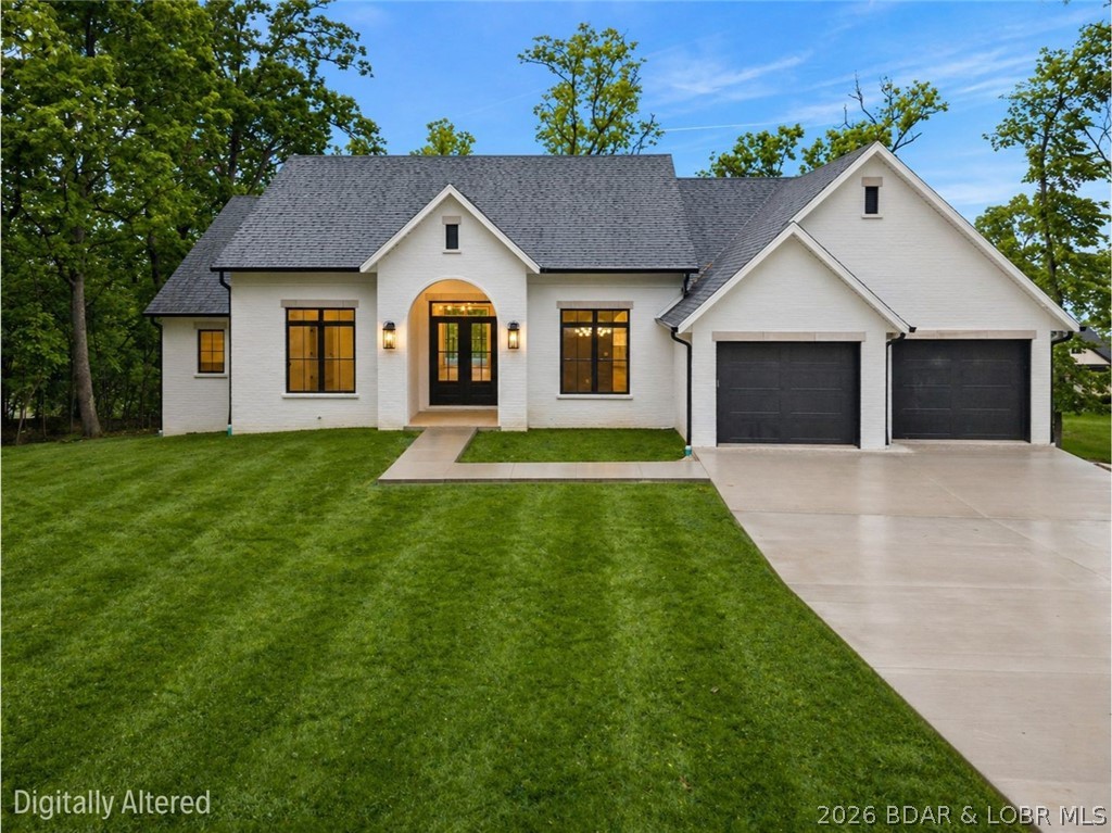 Impressive brand new construction in the sought-after Porto Cima subdivision! This stunning white brick home offers impressive curb appeal, thoughtful design, and gorgeous details throughout. Enjoy true main-level living with **no steps to enter**, an open-concept layout, a spacious dining area, and a walk-in pantry perfect for everyday convenience. The primary suite features a beautiful walk-in shower, while the home offers 5 bedrooms plus 1 non-conforming bedroom, giving you plenty of flexibility for guests, an office, or additional living space. The walk-out basement is made for hosting, complete with a massive family room, electric fireplace, and easy access to the expansive flat yard. A second electric fireplace adds warmth and style upstairs. Parking is a breeze with a large flat driveway, plenty of parking space, a 2-car upper garage, and a golf cart path leading to the lower garage for even more storage or workspace. Prime location close to shopping, dining, and top lake attractions. This is a home you’ll fall in love with and never want to leave!