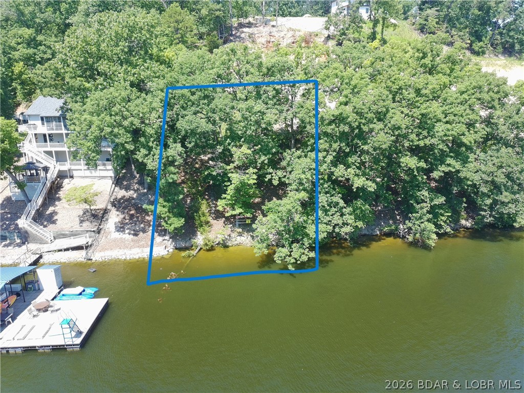 If you've been dreaming of building your own place at the Lake of the Ozarks, this waterfront lot is one you'll want to see. Offering approximately 95 feet of shoreline, this property provides the perfect setting to create your ideal lake retreat, whether you're planning a full-time residence, vacation home, or investment property. Enjoy beautiful water views, easy lake access, and plenty of room to design a home that takes full advantage of everything lake living has to offer. Spend your mornings on the dock with a cup of coffee, your afternoons out on the water, and your evenings taking in the peaceful views. Conveniently located with access to all the dining, entertainment, and recreation the Lake of the Ozarks is known for, this lot offers the opportunity to build exactly what you've been looking for. Waterfront opportunities with 95 feet of shoreline don't come along often—don't miss your chance to make this one yours.