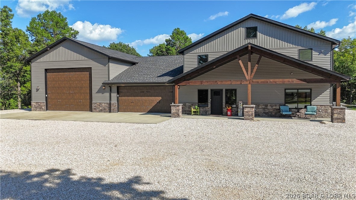 Luxury Barndominium living on 8.25 gentle acres in Rocky Mount, Missouri just minutes from Lake of the Ozarks, Coffman Beach boat access and nearby off-road recreation. This impressive 4-bedroom 3.5-bath property features new gated entrance combining upscale residential finishes, exceptional shop space and country functionality. Inside, the dramatic great room features 17.5-ft ceilings, solid hickory cabinets, hidden pantry, smart LG appliances, level-5 drywall and Pella wood-clad windows. A $40K whole-home mesh AV system includes 11 hardwired TVs, indoor/outdoor speakers, custom theater room with three 15-inch subwoofers. Primary suite offers a spa-inspired bath with soaking tub and warming stone. The 2,000+ sq ft heated/cooled shop, new epoxy floors, built with oversized 150-mph-rated steel doors, engineered trusses, 2x6 walls, Zip System roof, 30/50-amp RV hookups, sewer connection and theater. Outdoors, enjoy a Douglas fir timber-frame patio, ¾-mile trail and 5-acre Invisible Fence. Three HVAC systems, dual 50-gallon water heaters, water softener, pressure tank, Ring/Lorex security and extensive infrastructure complete this Lake of the Ozarks Barndominium with acreage and shop.