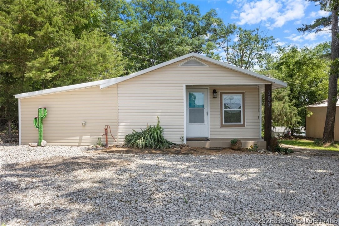 Welcome to your lake retreat! This darling cabin is in a quiet, community of Sunrise Beach, just minutes from all the attractions, restaurants, and conveniences the Lake of the Ozarks has to offer. Inside, you’ll find cozy, well-maintained living spaces with plenty of potential to make it your own. Outside, there's ample parking and a garage with additional storage, perfect for lake toys or tools. Enjoy peaceful lake views and the sights and sounds of nature from your covered deck, where deer, birds, and other local wildlife make regular appearances. Whether you're looking for a full-time residence, a part-time getaway, or a short-term, long-term rental investment, this property checks every box. Don’t miss this affordable opportunity to own a piece of lake life in a quiet neighborhood that feels like a world away, yet is convenient to everything. Very low maintenance with vinyl siding, desert landscaping, and metal roof.