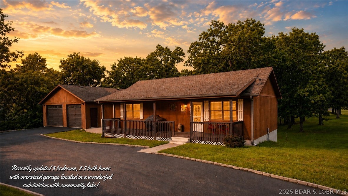 So many new updates in this beautiful 3 bdrm 2 1/2 bath home on an acre! Located in the wonderful lake community of Tebo Woods! Just around the corner from Thibaut Point Park on the shores of TRUMAN LAKE! Known for its world class fishing & boating. This charming lake home boasts of vaulted ceilings, spacious open floorplan with new luxury vinyl flooring in the main living areas. Beautiful walk-through kitchen with tons of cabinet space. Two nice size bedrooms on the main and a large main floor bath. Just off the kitchen, is a peaceful screened in porch to enjoy coffee before heading out to the lake. Lower level walk-out includes large family room with dining area, large guest bedroom full bath, 1/2 bath with laundry and large patio. The two levels make it possible for two families to enjoy this home as a lake get away. The home features a large covered front porch and fully paved driveway for parking or to maneuver the boat into the expansive 28x32 upper garage. The large garage also features a lower level for mowers, tractors or lake toys. The Tebo Woods community has a private lake for fishing or kayaking. Just minutes from the award winning lake community of Warsaw, MO.