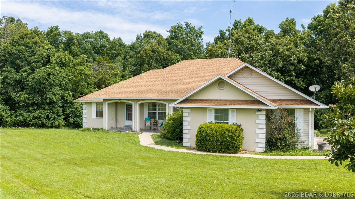 Discover the space and serenity of 16 acres with convenient Highway 52 frontage and endless possibilities, this beautiful ranch home offers the perfect combination of privacy, space, and convenience. The home features 3 bedrooms, 3 full bathrooms, with big open living room and formal dining area, this home was designed for comfortable living and entertaining. The spacious living room boasts vaulted ceilings, abundant natural light, and a wood-burning stove, creating a warm and inviting atmosphere. Hardwood flooring flows through the dining area while the kitchen offers ample cabinetry and workspace. The master bedroom includes a large walk-in closet and an oversized master bathroom. Additional features include a utility room, generous storage throughout, and a partially finished basement offering potential for additional living space, recreation, or workshop use. Outside, a long gravel driveway leads to the home, which is surrounded by mature trees and open acreage suitable for a variety of uses. Whether you are looking for a hobby farm, hunting property, country retreat or simply room to spread out, this property offers endless possibilities. HOME SOLD AS IS