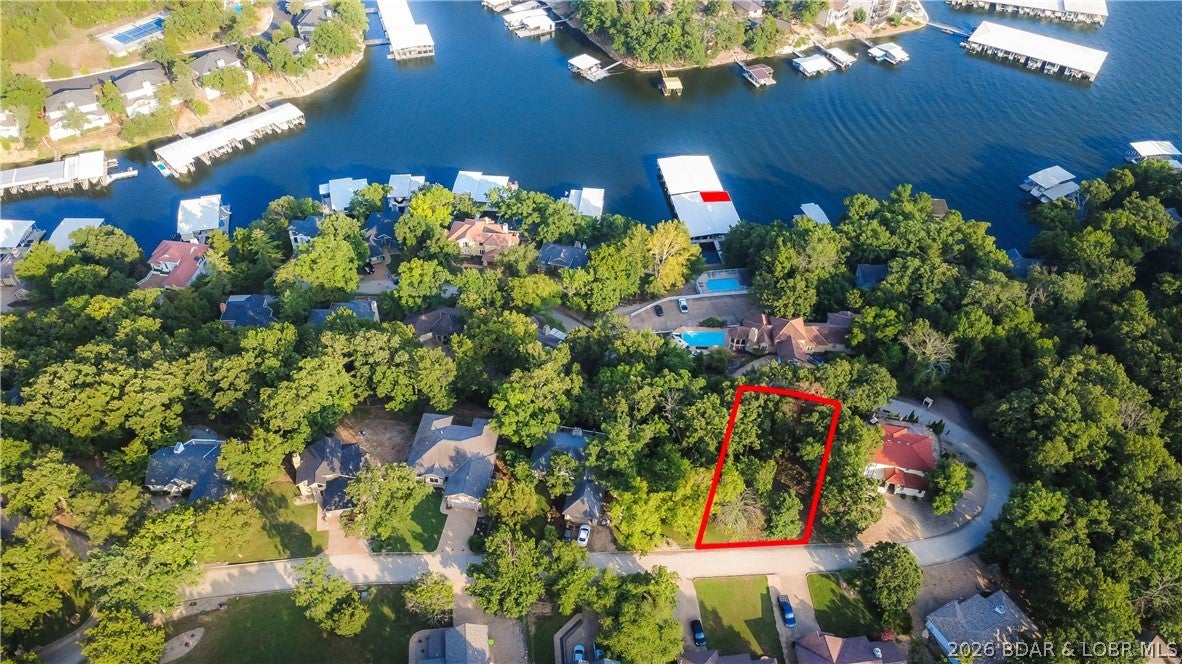 Build your Lake of the Ozarks retreat in the desirable St. Tropez subdivision, conveniently located just outside the Osage Beach city limits. This 0.25-acre lot is ideally suited for a walkout lower-level home and offers quick access to the community pool and dock. A 12x30 covered boat slip in the community dock is included, making it easy to enjoy days on the water. HOA assessments cover water and sewer service for all homes, adding convenience and value. Enjoy a well-maintained community setting close to shopping, dining, entertainment, and all the amenities Osage Beach has to offer. An excellent opportunity to build in an established subdivision with lake access, a pool, and your own covered boat slip!