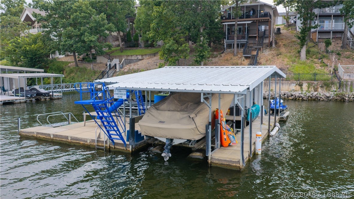 READY FOR LAKE LIFE? Check out this 3 bedroom, 2 bath lakefront home with two well modular concrete dock. The outside of the home has newer roof, siding and decks. (2022) The HVAC was installed in 2020.  Inside you'll appreciate an open concept living, dining and kitchen. The primary bedroom suite and large laundry are also on the main level.  The covered upper deck is great for enjoying the view. The lower level family room has a fireplace and access to the lower deck and hot tub deck. Two more bedrooms, another full bath and the utility room are on the lower level as well. The hot water heater and pressure tank were installed in 2022. Close to The Fish and Co., The Cave, Captain Ron's and The Hatch.  Nightly rentals are allowed and there is plentiful parking. This one could be your full time home, weekend getaway or investment property.
