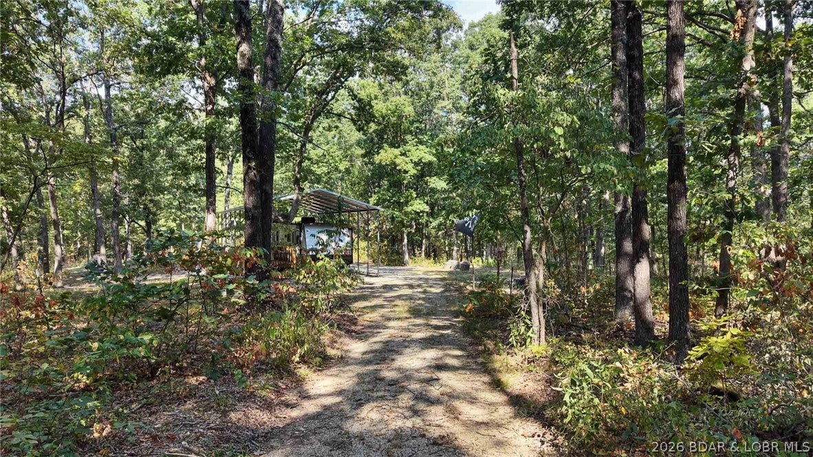 absolute paradise for relaxing and taking in nature. Having the well and septic system already in place gives you all the comfort you need, while the large carport provides excellent protection for your 32-foot trailer. Being so close to the lake and off a blacktop road means you get the perfect blend of easy access and peaceful seclusion.