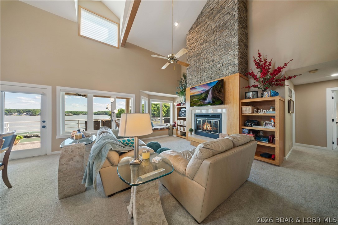 Move right in and start enjoying the lake! This turn-key, top-floor end unit at Emerald Bay offers 2,089 sq ft with 4 bedrooms, 3 baths, and breathtaking main channel views. Located just one level up from parking, the spacious open floor plan is perfect for entertaining, while the loft with a full bath provides an ideal second living area, guest suite, or additional sleeping space. The kitchen features Cherry Omega cabinetry, quartz countertops, stainless steel appliances, and a custom bar with a wine refrigerator and roll-out shelving. A separate laundry room and abundant storage add everyday convenience. Recent updates include new carpet, interior doors, trim, can lighting, LVT flooring in closets, deck carpet, new living room and north windows, beautifully updated hall and primary baths, and a modern electric water-vapor fireplace. Includes a 12x42 boat slip with lift plus a 12x24 PWC slip with lifts. Nightly rentals are allowed, making this an excellent full-time residence, vacation retreat, or investment opportunity.