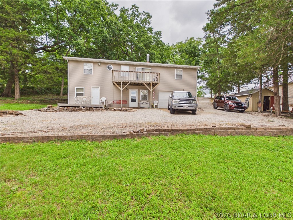 Don't miss this exceptional 4-bedroom, 2-bath lakefront home located at the 5 Mile Marker of the Little Niangua Arm. Situated on a rare flat lot with beautiful channel views, this property offers the perfect combination of convenience, functionality, and lake lifestyle.  Inside, you'll find approximately 2,400 square feet of living space, including a small workshop area in the basement—ideal for hobbies, storage, or lake projects. The home also features an oversized one-car attached garage and a detached boathouse/garage, providing plenty of room for vehicles, boats, and lake toys.

The waterfront includes a single-slip dock, along with ample shoreline and water frontage to accommodate a larger replacement dock (subject to permitting), giving you room to expand your lakefront experience.
Enjoy blacktop roads all the way to the driveway, abundant parking for family and guests, and easy access to the water with a gently sloping lot that's becoming increasingly difficult to find at the Lake of the Ozarks.
Whether you're looking for a full-time residence, weekend retreat, or investment opportunity.  This home deserves a spot on your short list—schedule your private showing today!