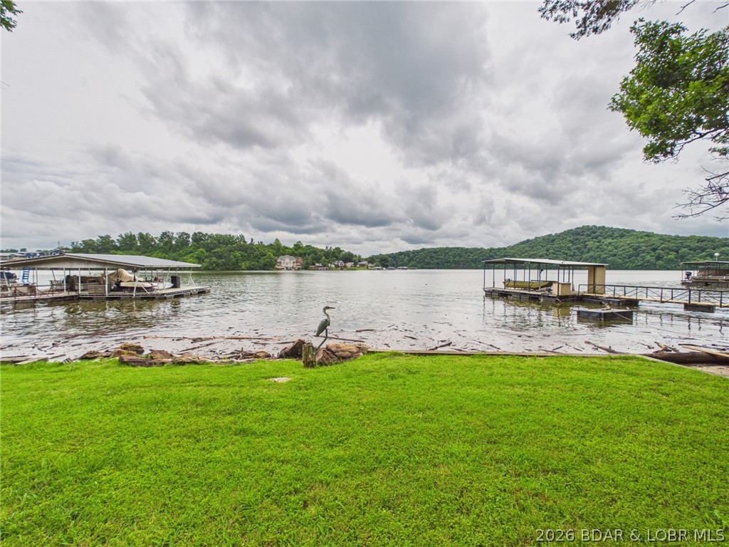 SELLERS ARE MOTIVATED AND OPEN TO ALL OFFERS!

Don't miss this 4-bedroom, 2-bath lakefront home at the 5 Mile Marker of the Little Niangua Arm. Situated on a rare .56-acre, gently sloping lot with beautiful channel views and 165+ feet of shoreline, this property offers the perfect combination of convenience, functionality, and the Lake of the Ozarks lifestyle.

With approximately 2,400 square feet, there's plenty of room for family and friends. A small workshop area in the basement is ideal for hobbies, storage, or lake projects. The oversized one-car attached garage and detached boathouse/garage provide plenty of room for vehicles, boats, and lake toys.

The waterfront includes a single-slip dock, with ample shoreline and water frontage that may accommodate a larger replacement dock, subject to permitting and approvals.

Enjoy blacktop roads to the driveway, abundant parking, and easy access to the water. Whether you're looking for a full-time home, weekend retreat, or investment opportunity, this property deserves a spot on your short list. Motivated sellers are ready to make a deal and open to all offers—schedule your private showing today!