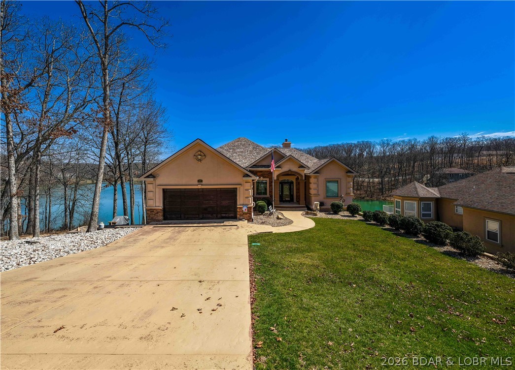 Set on the private waters of Treeline Lake in Four Seasons, this nearly 3,800 sq ft, 4 bed, 5 bath home delivers a rare level of privacy and a more exclusive side of Lake living. From the moment you walk in, the craftsmanship stands out with incredible woodwork, custom finishes, and thoughtful design throughout. The layout is both functional and flexible, featuring a dedicated office with stunning built-in wood desks and cabinetry, plus a bonus room ideal for a gym, extra sleeping space, or storage. The luxurious master suite offers a private retreat, while built-ins in every closet provide exceptional organization and storage. Enjoy nearly 1,200 sq ft of screened-in decking—perfect for morning coffee or unwinding in a peaceful setting. The lower level is built for entertaining, featuring an unbelievable man cave/grotto complete with a pool table, full wet bar, private sauna, and shower. Spacious two-car garage features mini-split system. Four Seasons amenities offer multiple pools, walking paths, a fitness center, aquatic center, and pickleball courts. Thoughtfully updated and move-in ready, this home offers character, comfort, and a setting that stands out from the rest.