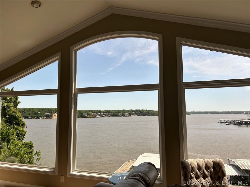 This stunning 5 bedroom home features breathtaking panoramic east facing lake views and a warm inviting atmosphere designed for making memories with family and friends. Expansive windows throughout fill the home with natural light and bring the beauty of the lake indoors.Multiple spacious decks offer the perfect place to relax, entertain and soak in the peaceful surroundings. The main level includes a large dining room, kitchen, living area with fireplace, master suite and guest bedroom The lower level is ready for fun with a full bar, family room, three bedrooms and bath. One bedroom has a cozy fireplace and sliding doors that walk out to a large screened porch.The garage was converted to a bedroom but can be converted back to a garage. A truly unique boathouse adds a rare opportunity to embrace lakefront living and the $75,000 wave break ensures calm water at your dock. The dock has a 12x32 slip which can be extended, a 10,000 lb. poly lift, two wave runner slips with lifts and large swim platform. The lakeside yard is nicely fenced for your furry friends to enjoy! This home is just minutes by car or boat  to restaurants, shopping, hospital and entertainment!