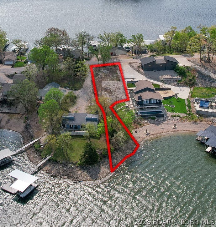 Discover one of the most impressive channel views on Horseshoe Bend from this beautiful lakefront vacant lot. With a gentle slope and a natural high point toward the top of the property, this lot offers an ideal setting to build your dream lake home while capturing a truly envy-worthy view of the water.

Position your home near the upper elevation of the lot to take full advantage of the sweeping lake and channel views, then enjoy easy access down to the water’s edge. A 44x38 dock is currently in the permitting process with Ameren and is designed to include a 14x40 slip, creating the perfect setup for lake living. DOCK NOT INCLUDED