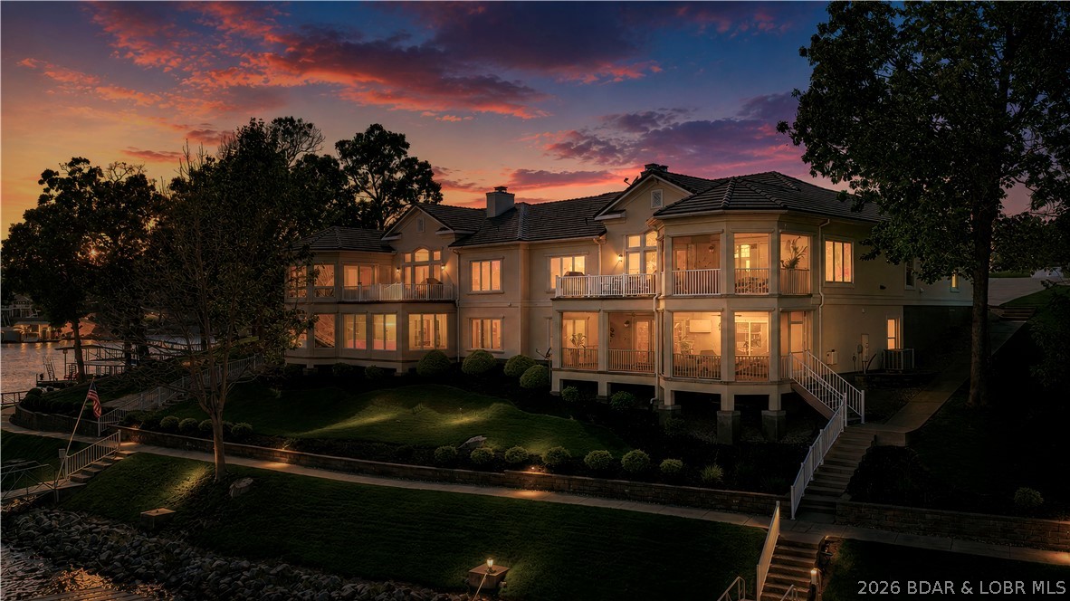 Experience luxury in Magnolia, the premier townhome development in Porto Cima. Setting a new benchmark as the most exclusive townhome ever offered here, 156 Cordoba Point delivers record-setting sophistication, meticulous upkeep, and a vibrant atmosphere. This 3,400 sq ft, two-story walkout captures the ultimate lakefront "sweet spot"—boasting magnificent main channel views while your private dock sits in calm, protected water. Your private dock features a locker, swim ladder, 2 PWC ports, and a boat slip, complemented by another boat slip and 2 PWC ports in the community dock. Fully updated, the 4BR/3.5BA floor plan shines with new fixtures and sleek, European-style flat-panel vanities. The kitchen features granite, maple cabinets, and black appliances. A screened patio sits off the dining room, alongside open decks. Both the upper living room and lower family room offer fireplaces, with a wet bar downstairs. The lower lakeside primary bedroom features a jetted tub and walk-in shower, mirroring the main primary suite. Enjoy a lower screened patio with a TV and fire bowl, near-flat driveway, oversized 2-car garage, and brand-new tile roofs. HOA covers lawn and exterior finishes.