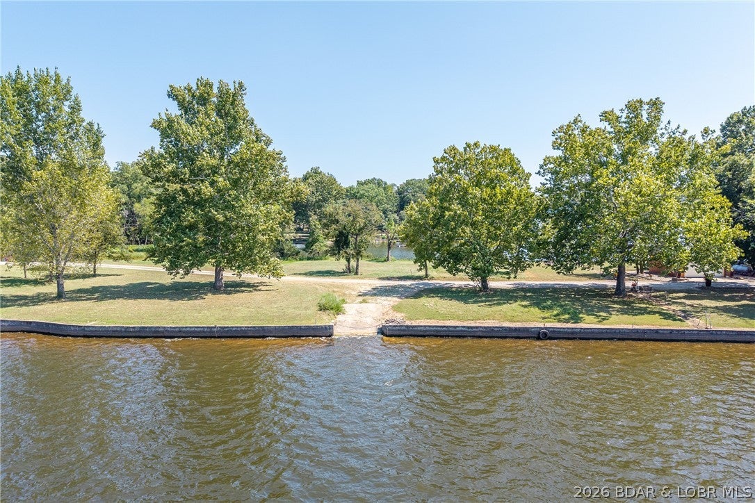 Must see to appreciate!!! 10.11 acres to build your secluded dream home overlooking the beautiful Lake of the Ozarks! Also featuring a second 80' of dockable lakefront just a walk down the road.  Invision summer days with picnics/gatherings lakefront & quiet evening retreats to your cozy woodland home.  The possibilities are endless and restrictions are few! 
(Community well available)