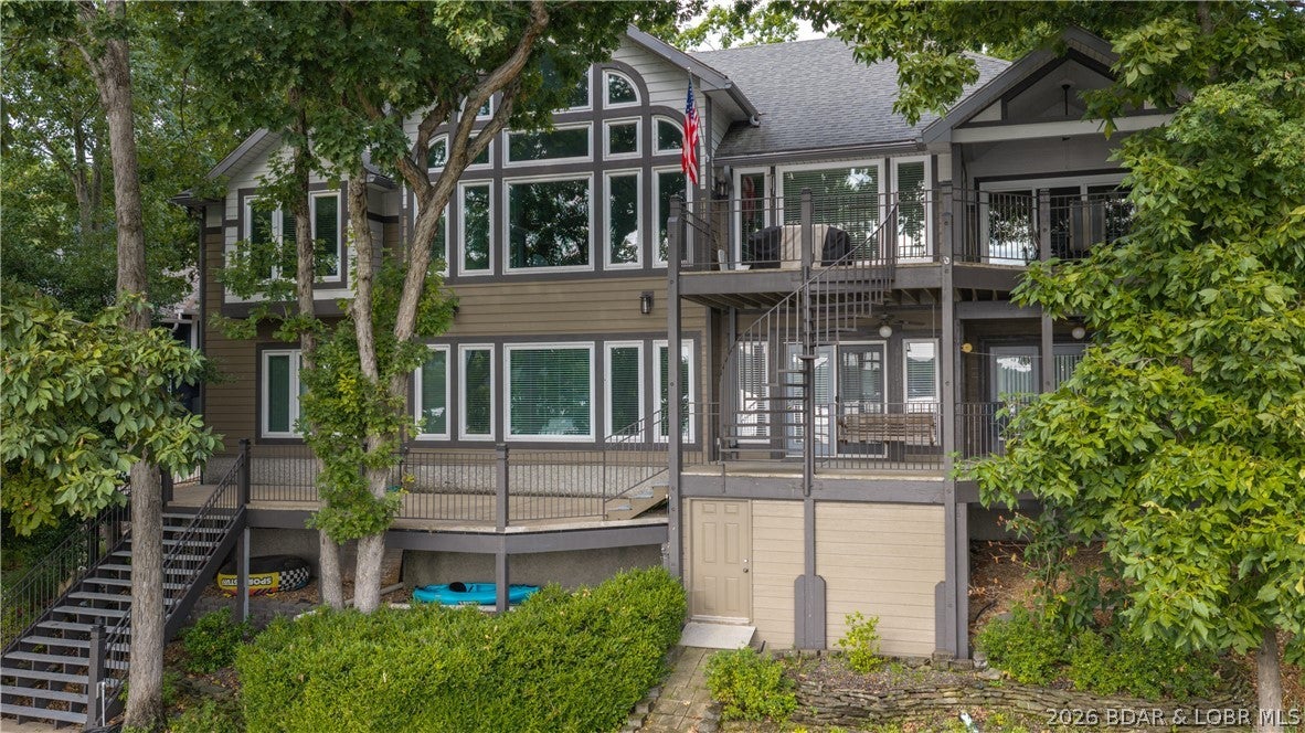 There’s a reason everyone knows 6 Mile Cove. Calm, protected water, beautiful homes lining the shoreline, and plenty of room to ski, swim, cruise, or simply sit back and enjoy the view. This 5 bedroom, 5 bathroom Four Seasons home puts you right in the middle of it all, with 130 ft of waterfront, a gentle lot, and a setup made for long days at the lake. Start your morning with coffee on the rare martini deck that extends over the water, then head down to the impressive 3 slip dock for an afternoon of swimming, boating, and soaking up the sun from the upper deck. There’s even a 16x32 swim deck, diving board, 2 ladders, storage shed, 6,000 lb hoist, and platform lift for 3 PWCs. Inside, 3 bedrooms feature ensuite baths and 2 bedrooms share a convenient Jack-and-Jill bath. The remodeled kitchen with double ovens and a gas cooktop makes gathering easy. Two gas fireplaces, an updated primary bath, new HVAC and water heaters, concrete decks, maintenance-free siding, owned propane tank, and more make this a home designed for enjoying the lake, not maintaining it. Add Four Seasons amenities and you have a place where lake days come easy and there’s always a reason to stay a little longer.