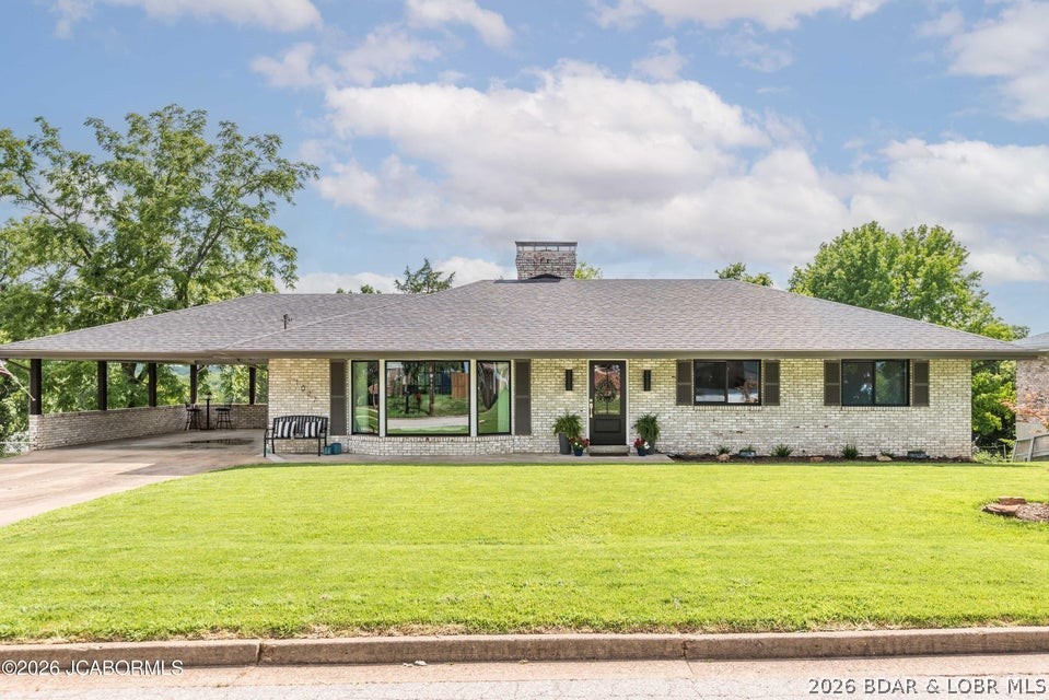 Beautifully updated and full of style, this exceptional 4-sided brick ranch on desirable Boonville Road blends timeless quality with modern design. Situated on a level lot, it offers the feel of new construction while maintaining the durability and charm of a classic brick home. Recent improvements include all-new windows, a new front door, and a new sliding glass door. The redesigned main level features hardwood floors throughout the living areas and new carpet in the bedrooms. The front living room, currently used as a dining room, showcases a bay window, glass-framed accent wall, and custom tile feature. The stunning kitchen offers granite countertops, a stainless prep island, two-tone cabinetry, stainless appliances, a gas range with vent hood, and a pot filler. The hearth room features a black brick wood-burning fireplace and opens to a spacious new deck overlooking the flat backyard. The primary suite includes a large walk-in closet and spa-inspired bath with a clawfoot soaking tub, tile shower, and double vanities. Two additional bedrooms, a finished lower level with a fourth bedroom, full bath, kitchenette, family room, and abundant storage complete this move-in ready home.