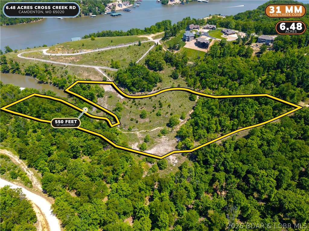 Rare opportunity to own one of the most impressive lakefront parcels to hit the market at Lake of the Ozarks. Over 550 feet of lake frontage on Linn Creek Cove at MM 31 with 6.48 acres of open and wooded ground, gentle to moderate terrain, and stunning cove views in every direction. Zoned PUD, giving a future owner exceptional flexibility for a private estate or residential development. The cove width supports two dock structures and preliminary dock drawings are available showing what could be permitted here. If you have been searching for the right canvas to build something extraordinary at the lake, this is it.