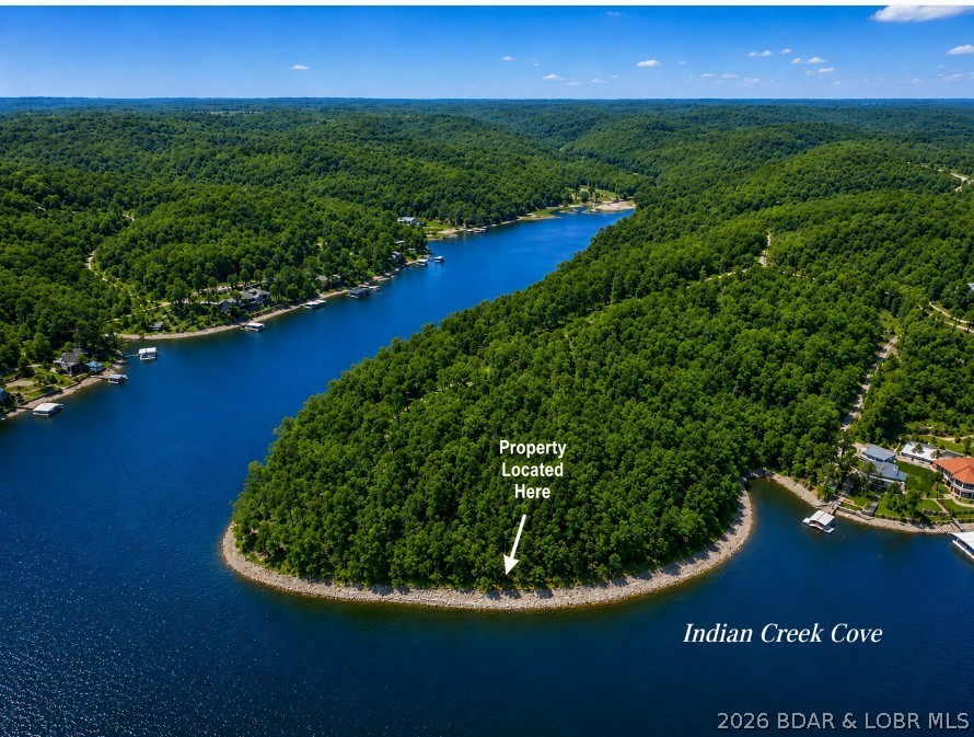 Rare opportunities like this are becoming increasingly difficult to find. This breathtaking south-facing point property offers exceptional waterfront in a large, boat-friendly cove with panoramic lake views, deep water, and expansive shoreline. Premium waterfront properties are a finite resource, and few can match the beauty, privacy, and desirability of this remarkable Lake of the Ozarks setting. Trustee for the trust is a lisenced real estate agent. Must have a scheduled appointment to see and /trustee/agent to accompany all showings.