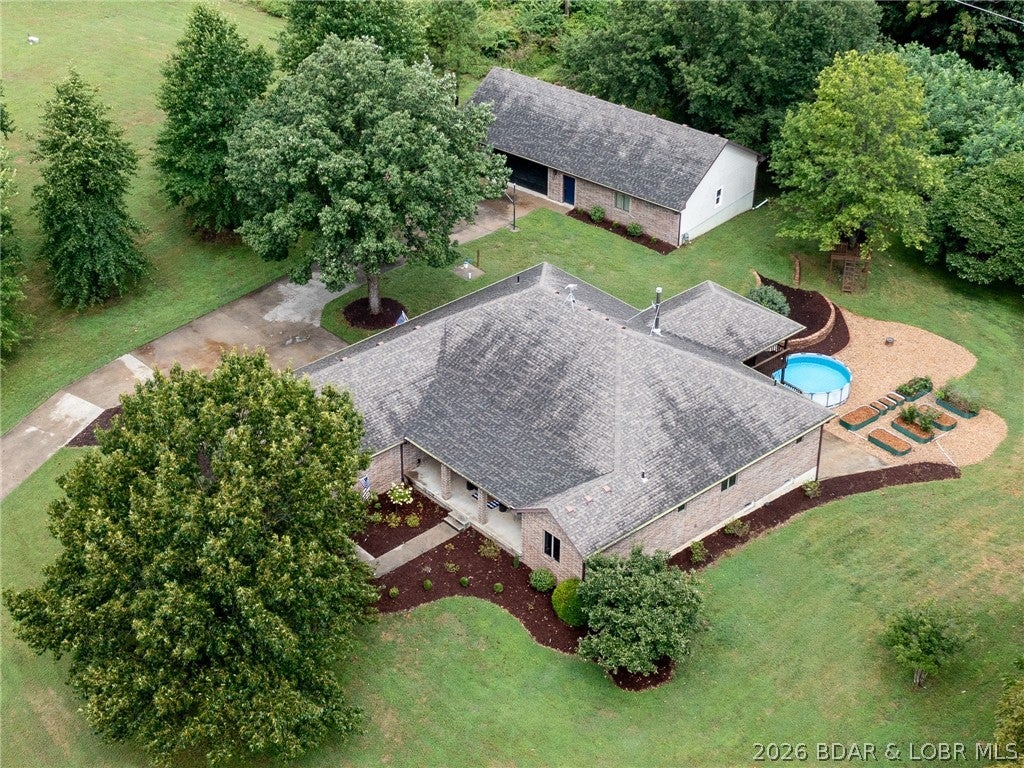 Welcome to your Truman Lake getaway! This all-brick home offers the perfect combination of comfortable living space, incredible outdoor access, and exceptional versatility. Featuring two separate living spaces and two full kitchens, this home offers endless possibilities for multi-generational living, extended family, guests, or simply having plenty of room to spread out. The detached garage is an incredible bonus, featuring approximately 1,800 sq. ft. of heated and plumbed space. Whether you need a workshop, boat and recreational vehicle storage, hobby space, additional workspace, or room for all your lake toys, this space offers tremendous flexibility. Outdoor enthusiasts will love the location! The property is just 5 miles from Sterett Creek Marina and approximately 7 miles from Shawnee Bend Public Use Area, making access to Truman Lake quick and convenient. Even better, the Truman Lake Mountain Bike Trails are located directly behind the property, with the trailhead approximately 2.5 miles away. Whether you're looking for a full-time residence, weekend lake retreat, multi-generational home, or a property with room for all your hobbies and recreational equipment, this one is it!