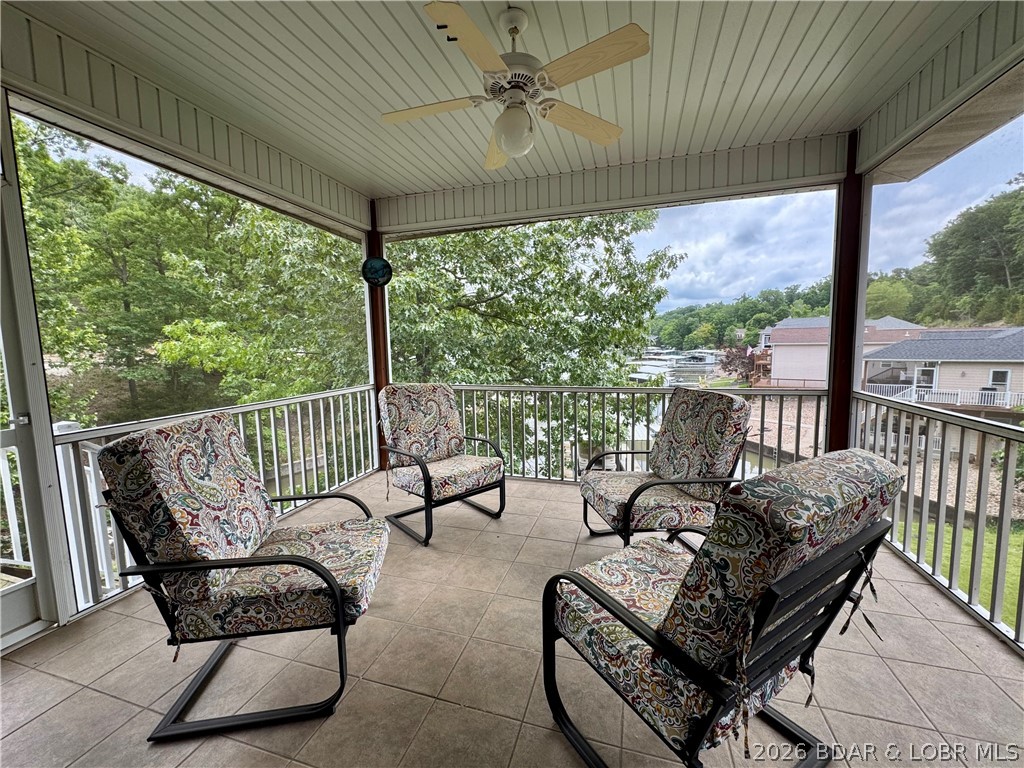 END OF SUMMER BLOW OUT SALE!!! Appraised $835,000 earlier this year - priced to sell. Cove deep enough for large boats! 38 ft speed boat frequently uses boat ramp. Plenty of room to get out! Don't pass up this peaceful Lakefront home - 26mm directly across from Margaritaville! Breathtaking views from every room!!! Multiple outdoor living spaces maximize lake views & outdoor entertainment. Complete w/ 12x30 concrete dock, boat lift, 24' pontoon w/150HP Yamaha (can stay or be removed), boat ramp, paved roads - NO gravel, HOA-covered water/sewer, LEVEL parking for 4+ vehicles + attached garage. Open-concept features soaring cathedral ceilings, gas fireplace, & dramatic windows showcasing the lake. Chef's kitchen offers stainless steel appliances & sunny breakfast nook that opens to large screened porch overlooking the water. Main-level primary suite features coffered ceilings, spacious walk-in closet, full bath w/double vanities, jetted tub, walk-in shower & private deck access. Walk-out lower level offers high ceilings & windows galore w/ spacious lakeside family room + 3 add'l bedrooms incl 2nd primary suite w/ full bath + oversized walk-in closet.  Bring your suitcase & enjoy life!