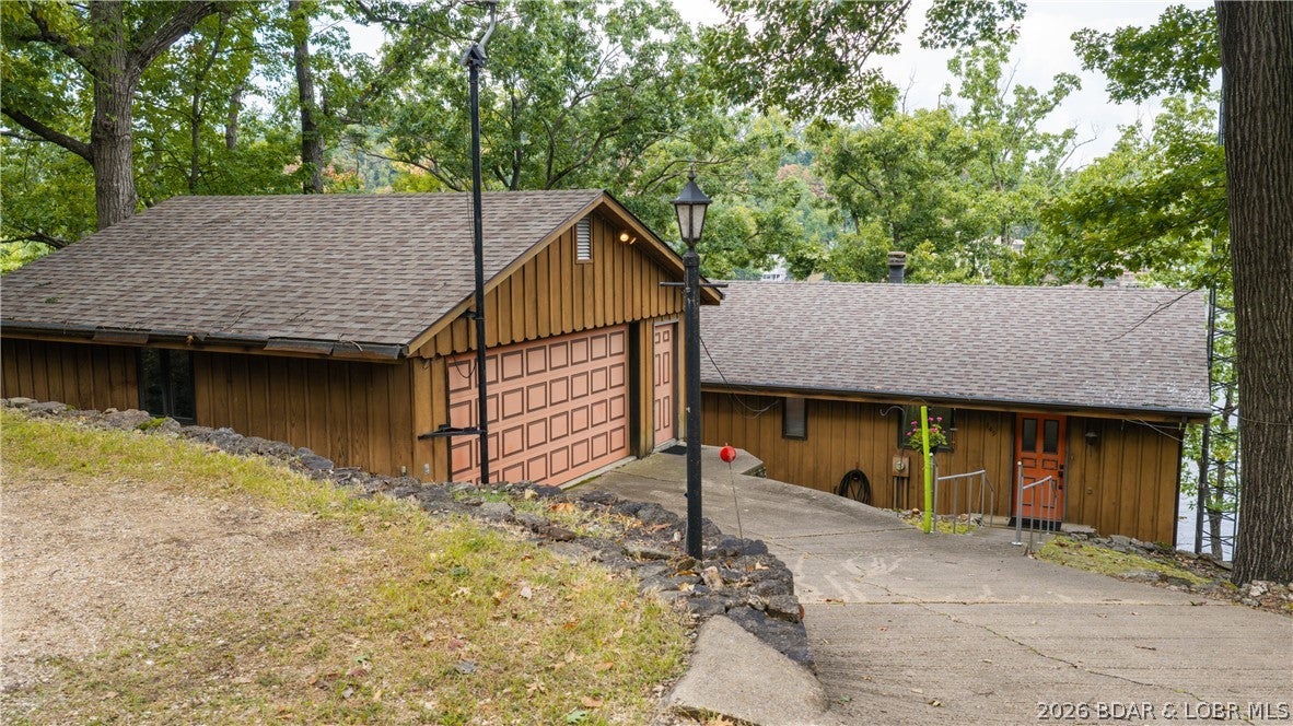 Rare lakefront opportunity off Horseshoe Bend in desirable McCoy Cove! The original owner/builder is offering this well-maintained 4-bedroom, 2-bath home for the first time in nearly 50 years. Priced under $500K, it features approximately 115' of waterfront, a large detached two car garage, original cedar siding, wood windows and doors, custom solid wood cabinets, a 2020 roof, and new HVAC in 2023. Pride of ownership is evident throughout—this home was built to last. The spacious lot offers plenty of potential, and the seller also owns two additional vacant lots, one on each side of the home, available for an additional price. Ideal for a full-time residence, second home, vacation rental, renovation project, or builder/investor opportunity. Property is being sold as-is. Wood decks and septic tank will need replacement. Septic laterals were inspected 9/11/26 and passed; report is available. A rare chance to own lakefront property in this coveted location with exceptional potential!