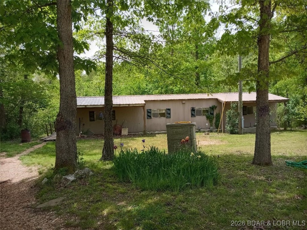 Two great lots with seasonal lake view to build your own home with sewer, water and electric already in place or stay in the single wide and enjoy lake life on a budget.  Could use some TLC but very livable.  Has a newer roof and is located not far from the Wigwam School Access and Conservation area boat ramp.  Just a mile off of paved Ivy Bend Road.