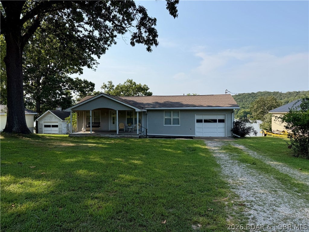 Lakefront home on the 7 mile marker of the Little Niangua at Lake of the Ozarks! This warm and welcoming 3 bed/ 2bath ranch has a great yard and an included additional lot! Lake view from the minute you walk through the door, charming barrel detail elevates the living room ceiling. Custom kitchen cabinetry with eat-in area overlooking the lake. Additional dining area and back deck make entertaining a breeze! Primary bedroom with en-suite is private and separated from the additional two bedrooms. Don't miss the cedar closet! New AC unit, kitchen flooring and dishwasher 2026. Additional lot is flat and perfect for future building plans, garden or storage for lake toys! Amazing views and peaceful waters at the dock with 98 feet of shoreline. Rentals are allowed in this subdivision making this a great home for investment, vacation or full time living. Must see to appreciate. Not available to rent only a sale.