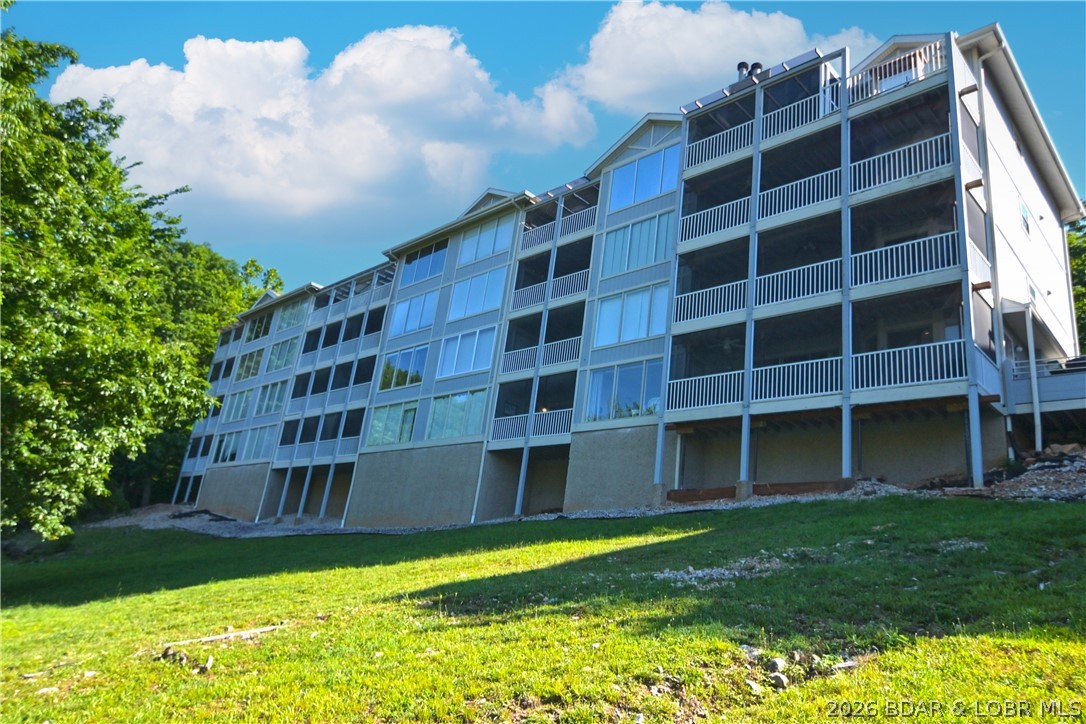 Welcome to Regatta Bay, one of the Lake's most unique waterfront communities. Unlike many developments, Regatta Bay offers an abundance of green space, mature trees, & resort-style amenities that encourage an active outdoor lifestyle. Enjoy 2 lakeside swimming pools, tennis/pickleball courts, playground, fire pit, & plenty of room to walk and enjoy the beauty of the Ozarks. This fully furnished 3-br, 3-bath condo features a desirable 2-level floor plan with multiple lakeside decks. Main level offers a bedroom and bath, while the lower level includes 2 private bedroom suites, making it an ideal for rental income potential. The unit includes a 10x30 boat slip with lift plus a PWC lift. Located at the 12 Mile Marker and just off Horseshoe Bend Parkway, you'll appreciate the convenience of this central location.  Regatta Bay recently completed a 3 year special assessment project focused on improving and updating the community. Building 80 is scheduled to be among the next buildings improved, and the special assessment has already been paid. If you're looking for a community where you can enjoy amenities, green space, and lake lifestyle this is the opportunity you've been waiting for.