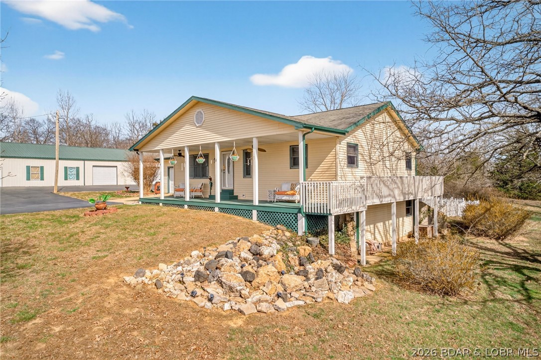 LIVE, WORK & PLAY!
This incredible property offers over 7,800 sq ft of shop space, with a 3 bay 100x50 shop area as well as a 70x40 RV storage bay.  Shop can easily accommodate 15+ vehicles, along with a dedicated workshop and bathroom, a dream setup for hobbyists, business owners, or collectors.
Perfectly situated on a sprawling 4+ acre lot, just 10 minutes from the heart of Osage Beach, this property delivers both privacy and convenience.
Relax and unwind with stunning sunset views from the covered front porch or entertain all summer long on the back deck featuring a pool and BBQ area—ideal for gatherings.
Inside, you’ll love the open floor plan with convenient main-level living. The bright and inviting four seasons room offers year-round enjoyment and direct access to the fenced backyard and pool deck.
The lower level adds even more living space, complete with a cozy wood-burning stove, an additional bedroom with walkout access, a full bath, and plenty of storage. NEW ROOF, new well pump 2022, ultraviolet water purification system and new kitchen appliances in 2022!!