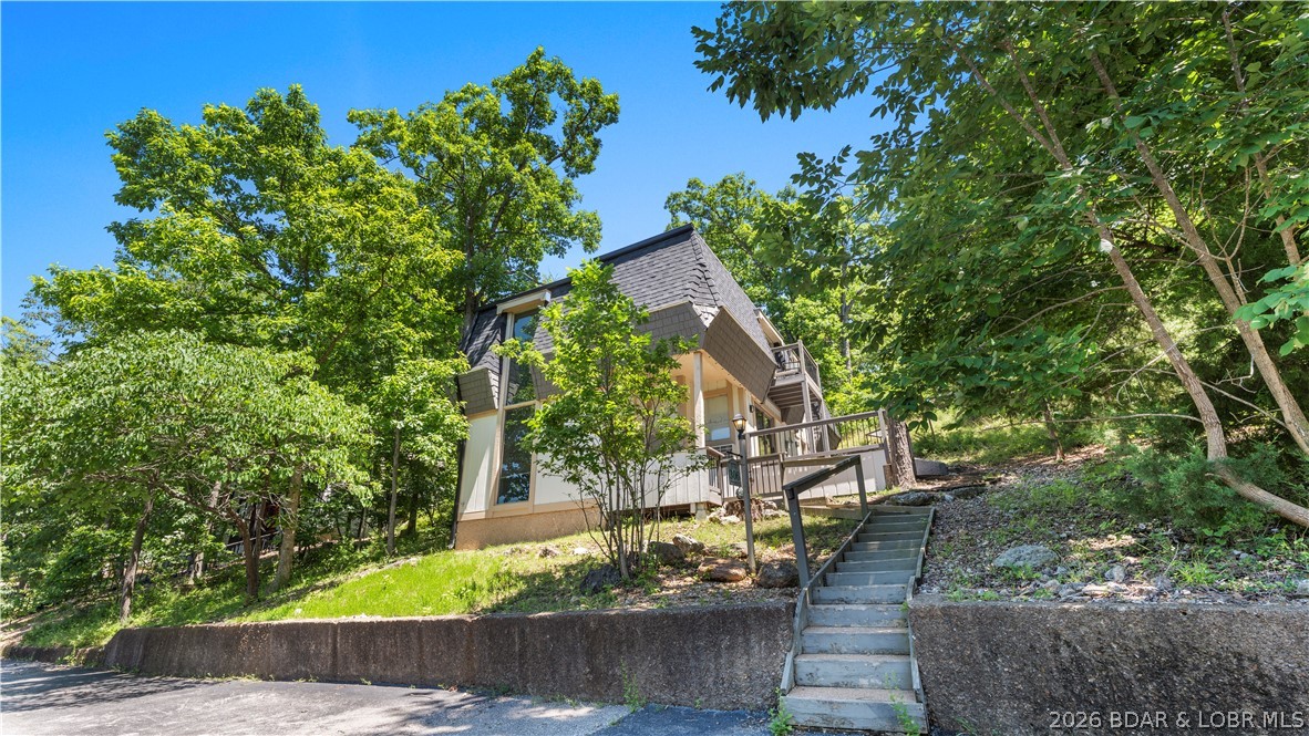 Excellent investment opportunity in the heart of Osage Beach! This unique turn-key property offers three fully furnished rental units under one roof, providing exceptional flexibility and income potential. The walk-in main level features a full kitchen, fireplace, laundry room, and spacious primary suite with king bed, walk-in shower, and walk-in closet. The upper level includes two separate rental units, each offering two king beds, a full bath, kitchenette, private balcony, and individual heating and cooling systems.
Recent updates include four new PTAC units, interior and exterior paint, granite countertops, appliances, water heater, light fixtures, updated bathrooms, and a new roof in 2023. Whether you choose to live in the lower unit and rent the upper units or maximize revenue by renting all three, this property offers proven income-producing potential. Rental records from 2023, 2024, and 2025 are available. Conveniently located with lake access and just minutes from Margaritaville, LandShark, shopping, dining, and entertainment. A rare opportunity to own a successful, fully furnished investment property at Lake of the Ozarks.