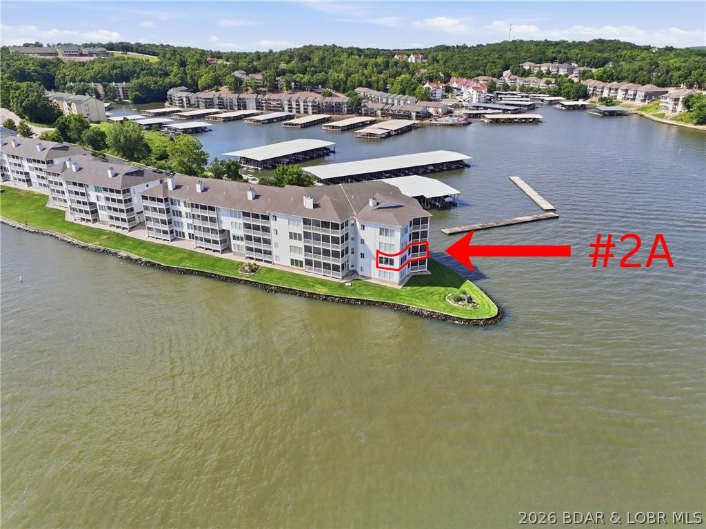 Regatta Bay condominium with walk-in level entry and an east-facing main channel view. Features 3 bedrooms, 3.5 baths, a screened deck, wood-burning fireplace, and 10-foot ceilings throughout. Floor-to-ceiling lakeside glass windows showcase stunning lake views, while crown molding adds elegance throughout.  The living room includes a wet bar, and the kitchen bar  provides additional workspace and seating.  Foyer, kitchen and all bathrooms have tile floors. The primary suite features a walk-in shower and walk-in closet. Both guest bedrooms are private suites with full bathrooms and one with walk-in closet. All new windows in 
living room and primary bedroom.