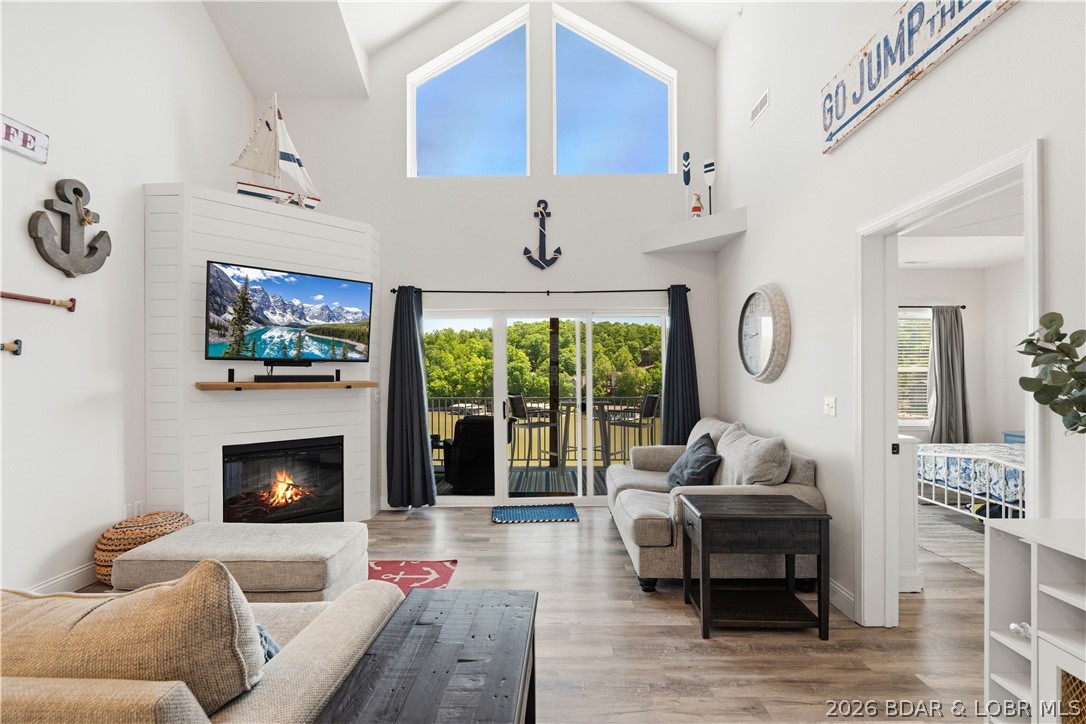 This is the kind of lake condo people wait for—top-floor views, beautifully updated, completely turn-key, and ready for you to enjoy from day one. Nightly rentals are allowed, and the boat lift is already in place for summer! This stunning 3-bedroom, 2-bath Loch Haven condo offers elevator access to the condo, lakeside pool, and dock, making lake weekends effortless. Inside, you'll find laminate flooring throughout the living room and bedrooms, quartz countertops, stainless refrigerator, microwave and dishwasher, freshly painted kitchen and bath cabinets, updated hardware, ceiling fans, new toilets, storm door, and a gorgeous shiplap fireplace with a new mantle. Sold fully furnished, it's perfect as a personal retreat or income-producing investment. Unwind on the deck overlooking the lake, then head out from your included 12x36 boat slip with added decking and dock box. Just minutes from Ha Ha Tonka, golf, Camdenton, and popular waterfront restaurants including Fish & Company, Larry's on the Lake, NautiFish Rum Bar, and Captain Ron's. This is lake living at its absolute best.