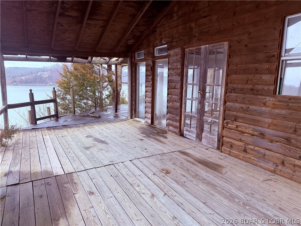 Wake up each day to breathtaking panoramic lake views from this bluff-top property offering one of the most dramatic vantage points on the water. The existing home is a fixer or a possible tear-down, giving you the rare chance to design and build exactly what you want in a setting that’s impossible to replicate. Perfectly perched above the shoreline, the lot delivers elevated, unobstructed vistas and year-round scenery, from peaceful sunrises to stunning sunsets. Whether you envision a modern full-time residence or a custom vacation retreat, this property provides the ideal canvas. Create your dream home and enjoy some of the most spectacular views on the lake.