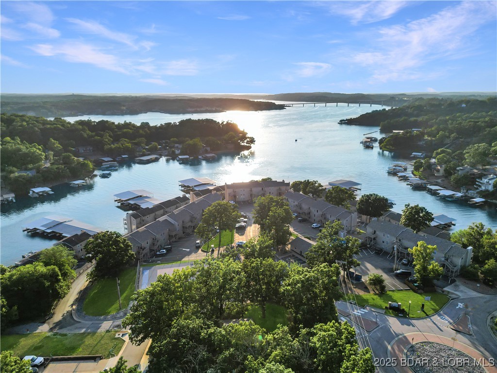 Your year-round Lake escape is ready and waiting. This fully furnished 2-bedroom, 2-bath condo at Indian Pointe offers expansive views of the Main Channel and is perfectly located just off Highway 54—close to Hy-Vee, Marshalls, home stores, and a variety of popular restaurants and bars. Situated at the 17MM in a protected, deep-water cove, the complex is just around the corner from the well-known Backwater Jack’s, placing you right in the heart of Lake of the Ozarks activity.
The condo is move-in ready with updated appliances and includes a full-size washer and dryer. A 10x28 boat slip is also part of the package, making it easy to get on the water anytime. Indian Pointe is a highly desirable complex offering amenities such as lakeside pools, a scenic boardwalk, tennis courts, a playground, clubhouse, and trailer storage. Whether you’re looking to enjoy the lake lifestyle personally or generate income through nightly rentals, this property offers flexibility and investment potential.

Now is the perfect time to secure your place at the Lake. Take a look at the video tour to get a full view of everything this opportunity has to offer.