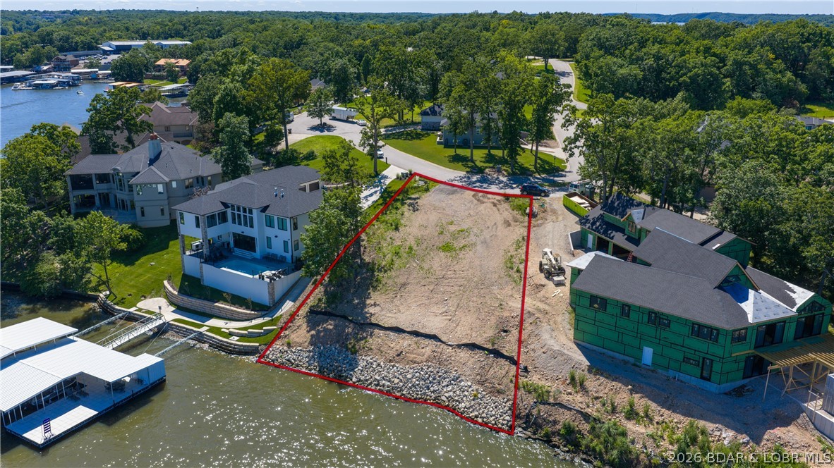 Discover the perfect setting for your custom lakefront dream home in the heart of Osage Beach! This is the last available waterfront lot in the prestigious Nichols Point Estates, offering an incredible combination of privacy, convenience, and premier lake access. Featuring 113 feet of cove-protected shoreline with an expansive dock envelope, there's plenty of room for multiple boats, including 40'+ cruisers. Enjoy peaceful waters while remaining just minutes from shopping, dining, entertainment, and the hospital. Nearly ½ acre, this surveyed lot is development-ready with city water, city sewer, natural gas, Ameren electric, and high-speed internet already available. Nichols Point Estates is one of Osage Beach's most desirable neighborhoods, showcasing beautiful new construction alongside luxury established homes in a scenic, park-like setting. Conveniently located by water at the 19MM or by land just off Nichols Road, this exceptional property offers the ideal blend of tranquility and accessibility. Don't miss this rare opportunity to build in one of the Lake's most sought-after communities!