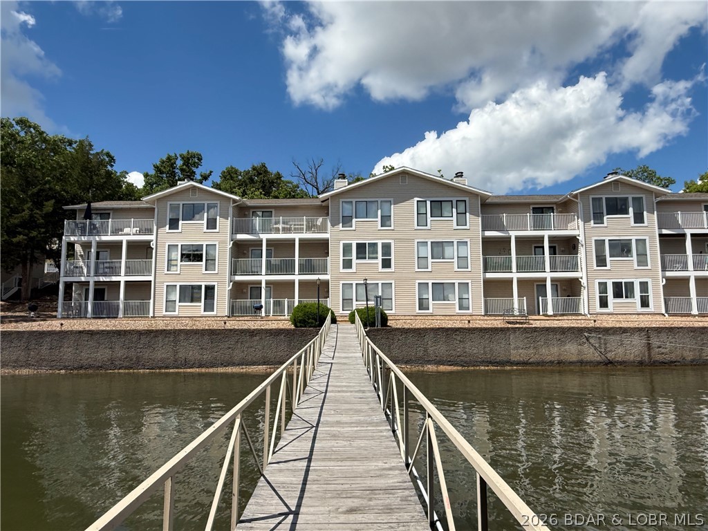 Beachfront living in the heart of Osage Beach! Located in highly desirable Kapilana Estates - where nightly rentals are allowed. This beautifully maintained 3-bedroom, 2 bath condo offers the perfect blend of lake lifestyle and income potential. Just minutes from Dog Days Bar and Grill, Twisted Tonys, and Chevy's! You'll love being in the center of it all! Enjoy lakefront access  with just steps away from the community pool. Inside, the spacious kitchen features abundant cabinetry, a center island, and an open-concept layout that flows seamlessly into the living area - ideal for entertaining or relaxing after a day on the water. Take in stunning Lake of the Ozarks views, stroll the shoreline, and enjoy the convenience of two 10x24 boat slips perfect for lake lovers and guests alike. Whether your looking for a personal getaway, full time lake retreat, or a highly desired investment property, this condo truly checks all the boxes.
