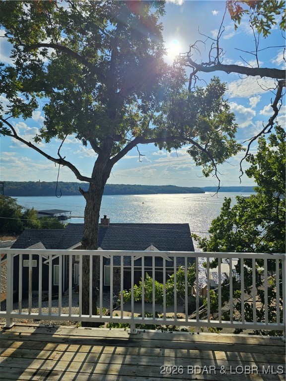 Experience Lake of the Ozarks living at its best in this well-maintained 4-bedroom, 2-bath home located in the quiet Shorewood Estates neighborhood of Osage Beach. Designed for comfort and flexibility, the home offers convenient main-level living plus a spacious lower-level living area currently used as the 4th bedroom, complete with a large walk-in closet and walkout access to a private patio. As a desirable second-tier property, enjoy views overlooking the iconic Shootout Race Course near the 1-mile marker of the Grand Glaize Arm. Whether you’re searching for a full-time residence, weekend getaway, or investment opportunity, this property offers exceptional versatility with vacation rental and monthly rental potential allowed. Additional features include ample parking for multiple vehicles, a peaceful setting, and a highly convenient location close to shopping, dining, entertainment, the business district, and the upcoming Oasis at Lakeport development. Motivated seller and a CHW Home Warranty is now included—making this an even stronger opportunity at the Lake.