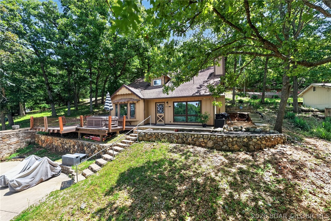 Lake view and lake access home at the Big Niangua 2MM with convenient Hwy 5 access. Priced to reflect the need for a new septic system, this property offers outstanding potential for investors, flippers, or buyers looking to create an affordable lake retreat. Approximately 1,400+ sq. ft. with 3 bedrooms and 1.5 baths. The main level features a kitchen, living room, laundry, half bath, and bedroom, while the upper level offers two additional bedrooms and a full bath. The home is partially finished and will require completion of interior trim and septic installation. Relax on the spacious front deck with lake views or unwind in the hot tub after a day on the water. A 10x20 community dock slip is included, providing easy lake access. Conveniently located near The Cave Bar & Grill, Nauti Fish, and just minutes from the 31MM, with easy access to both Camdenton and Greenview. A great opportunity to build equity at the Lake of the Ozarks.