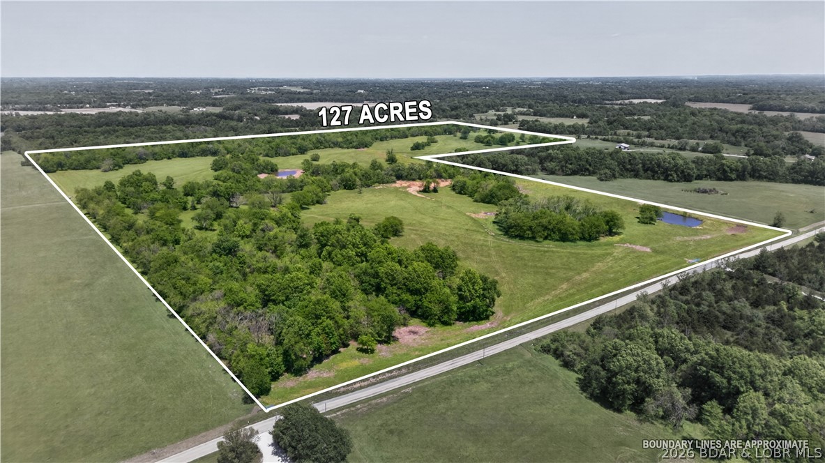 127.35± acres located near Warrensburg, Missouri, offering exceptional development potential in a highly desirable location. Conveniently situated approximately 1¼ miles from Highway 50 and just minutes from Warrensburg, this versatile tract combines accessibility, privacy, and endless possibilities. With gated access from two different roads, the property provides excellent opportunities for future subdivision, multiple building sites, or creating a private estate development. Existing fencing and the layout of the land would allow for an easy road system connecting different portions of the property, making development planning even more practical. The land features multiple ponds along with a balanced mix of timber and open pasture, creating a scenic setting ideal for residential development, recreational use, farming, or livestock. Whether you are looking to invest in future growth, build your dream home, develop multiple homesites, or enjoy a combination of recreation and agriculture, this property is well-equipped to accommodate a wide variety of uses. Rarely does a tract of this size and location come available with this much flexibility andlong-term potential.