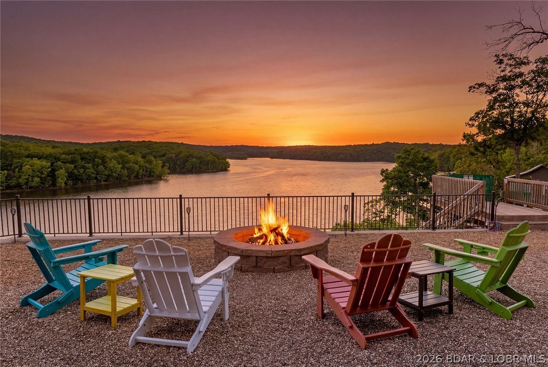 What a VIEW! Tucked in a private setting, but with the convenience of being 20 minutes to Warsaw or Lincoln, this property has it all! Featuring main level living with primary suite, open living, inviting kitchen, and views out the back to make your dreams of a peaceful lake lifestyle come true. In the basement you'll find another living area, 2 bedrooms and another full bath with all windows viewing the water. Watch the bald eagles in your back and front yards, enjoy the firepit with a view, and an easy tram ride (with a max weight of 800 lbs) down to the 2-well dock which has been serviced every year and functions smoothly and quietly to help you get down to the water with ease. Owners have also added an RV hookup for those friends and family who come with their own space...or for overflow when you have those big gatherings with friends and family. With just over 1 acre (2 separate parcels at around .5 acres each) you have space to enjoy your yard and home, plus room to build a shop, cabin, or build a 2nd tier home to sell...with  no restrictions... your options are limitless! Call today to get more information and to schedule a showing!