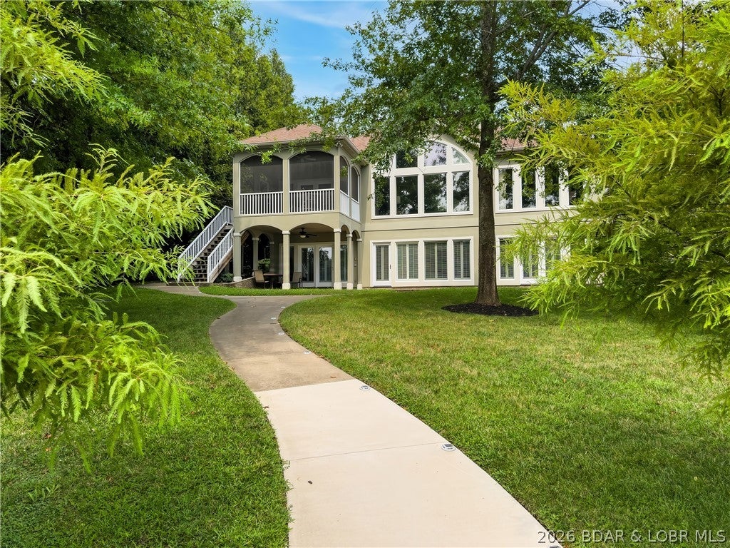 Lakefront living at its best on the 11MM of the Big Niangua in the coveted Woobridge subdivision. This quality built, luxurious 5-bed, 4.5-bath home offers 3,464 sq ft with a thoughtful layout, quality finishes, and perfect lake lot with irrigation. The level lot from driveway to shoreline with golf cart path is a rare find. You'll enjoy 2 living spaces with wooden plantation shutter throughout, a well-appointed chef's kitchen, and off the dining area a screened deck overlooking the lake. Three of the 5 bedrooms feature ensuite baths, making the home ideal for hosting family and guests. Recent improvements include a newer roof, updated guttering and exterior paint, new HVAC in 2019, and updated flooring in the lower level, and just installed new upper windows in the living room.The custom 3,328 sq ft dock is a true highlight featuring 3 boat slips 2 with hoists, (14x48, 12x40,  10x27)  plus a 16x14 PWC slip accommodating 3 personal watercraft, dock locker, swim platform, and high dive—creating the complete lakefront experience. From the craftsmanship of the original build to the meticulous maintenance by the current owner, this property reflects attention to detail throughout.