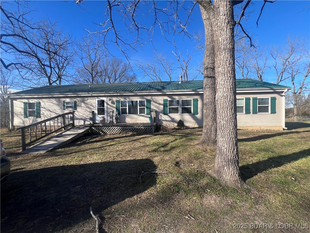 This is a beautiful setting close to town but yet private. This is an open floor plan well kept modular home with a large open kitchen with custom cabinets and center island. Master has a full bath with jetted tub and separate shower as well as a big walk in closet. The 2 remaining bedrooms also have walk in closets and one of those bedrooms has its own full bath. Also has a large screened in back deck that overlooks the very stocked pond.  There is also a 1 bdrm guest house with 1 car garage on property as well as a detached garage and other outbuildings. The home sits on 15 beautiful park like acres. Roof was replaced end of 2024. This would make a great place for that homestead you have been looking for. The carpet and other flooring needs some care and seller will allow a 25,000.00 allowance for replacement. Owner is willing to subdivide acreage for right price .