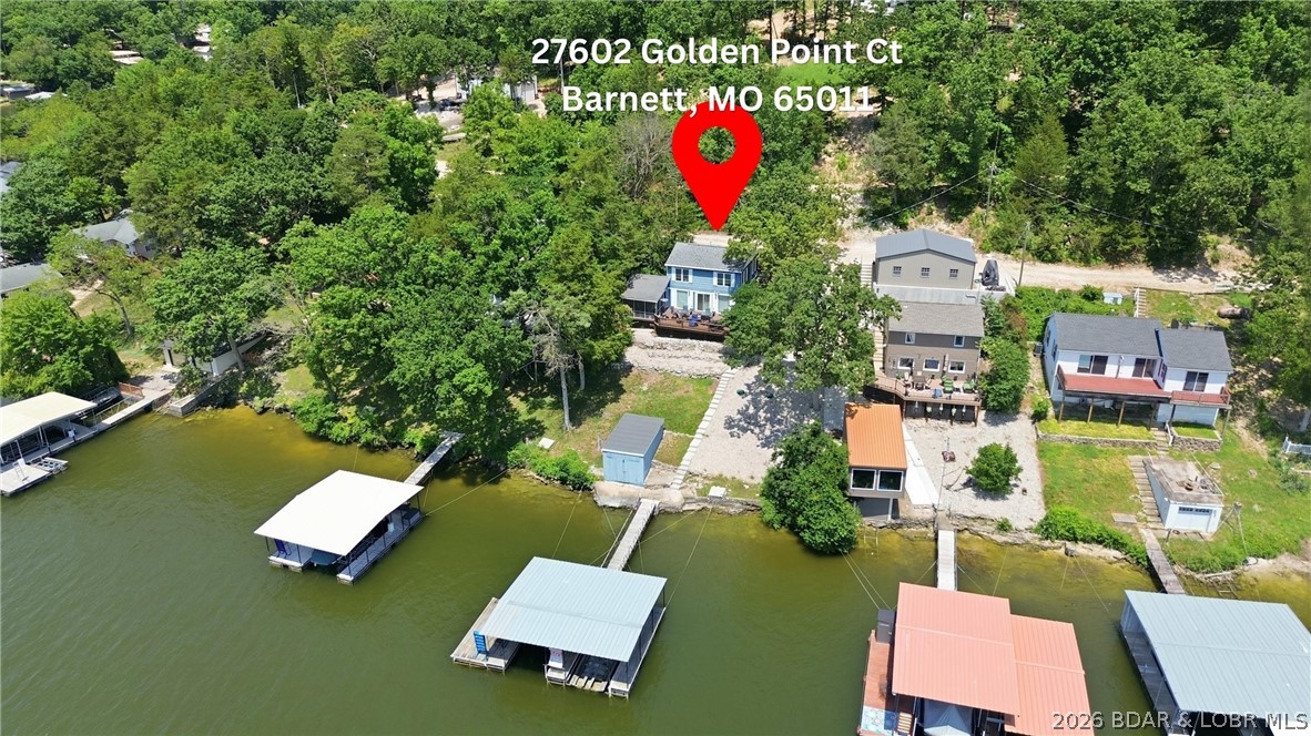 Tucked along the shoreline in year-round deep water, this lakefront cabin is the kind of place families buy to make memories for years to come. From mornings on the screened porch to afternoons on the dock and evenings on the oversized lakeside deck, this home was built for enjoying the lake lifestyle.

The home offers 3 bedrooms, 2 bathrooms, plus additional BONUS ROOM heated and cooled sleeping space for extra guests. The bonus room has a futon and an extra beer fridge! Major updates have already been completed, including granite counters, paint, and flooring.  NEW WELL PUMP AND BRAND NEW SEPTIC , and the home comes furnished so you can start enjoying it immediately.

The easy walk to the 2-well dock with swim platform, hoist, and storage makes lake days effortless. Located in deep water with a protected feel, this setup is hard to find at this price point. Rentals are allowed, giving flexibility for full-time living, weekend use, or investment potential. By water, you’re close to Jolly Rogers, Coconuts, and Tap & Grill while still feeling tucked away in your own private lake retreat. Room to add more parking or a garage in needed. Its your OWN VERY LAKE CABIN, CALL TODAY!