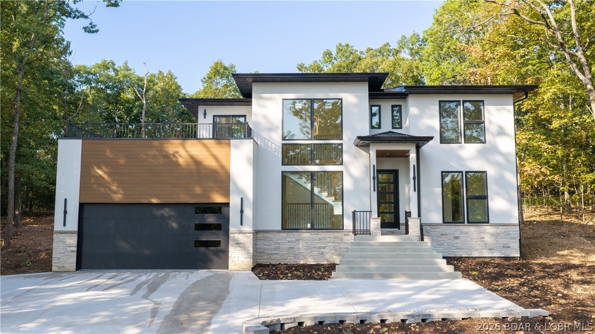 New Construction with a private pool in prestigious Porto Cima! This stunning 4BD/2.5BA home combines modern luxury, seasonal lake views and a private wooded setting with the resort lifestyle Porto Cima is known for. Beautifully designed with upscale finishes throughout, the main level features impressive tile flooring, a sophisticated dining room and stylish coffee bar. Step outside to your own backyard oasis, where a sparkling pool surrounded by mature trees creates the perfect setting for relaxing, entertaining and summer days at the Lake. The primary suite is a true retreat with floating vanities, a freestanding tub and versatile flex space ideal for a custom closet, dressing room or fitness area. Enjoy evenings on the upper deck taking in seasonal lake views or stargazing, with an indoor bar conveniently located just inside. An epoxy-finished garage adds the finishing touch. With membership, The Club at Porto Cima is just a short golf cart ride away, offering championship golf, dining, pool, fitness center and marina. Luxury, privacy and the Porto Cima lifestyle—all in one exceptional new home. Taxes will be adjusted - current taxes are for lot only.
