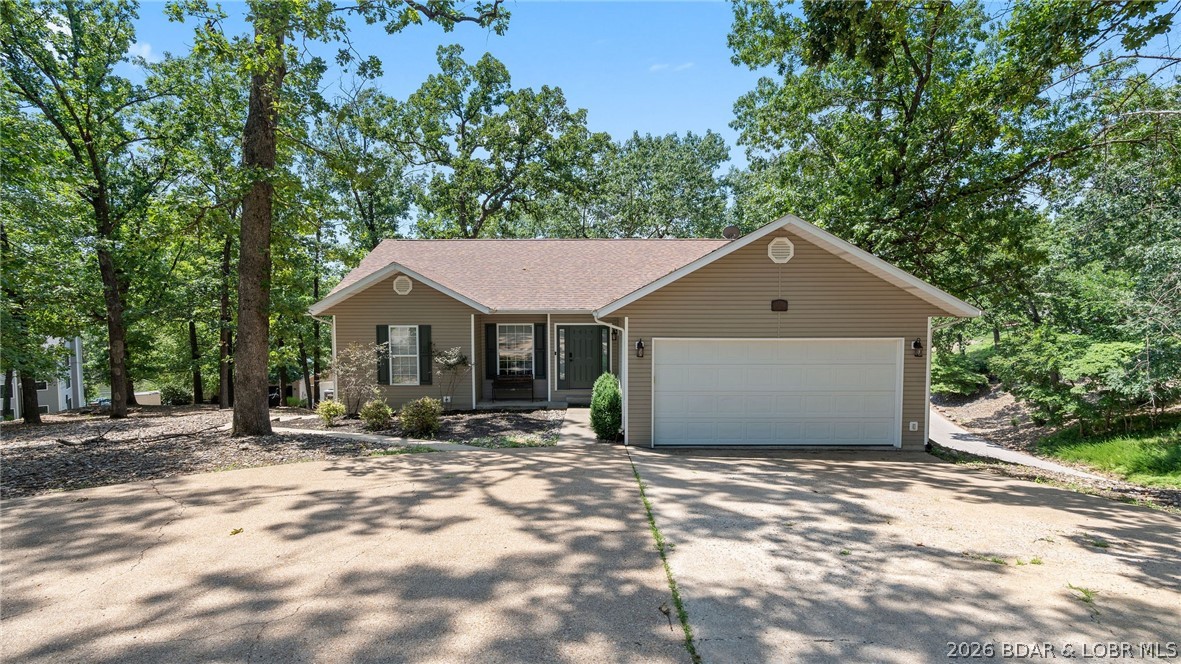 Experience elevated lakefront living in this luxury 4-bedroom, 3.5-bath home offering true main-level living and an open-concept design. Enjoy stunning, year-round views of the Lake of the Ozarks at the 28-mile marker, with 100 feet of private lake frontage. Outdoor spaces are designed for both relaxation and entertaining, featuring a martini deck perfect for sunset evenings and direct access to the water. The private dock includes a 1-well slip and two PWC lifts. Inside, the lower level offers a spacious living area with a wet bar—ideal for hosting guests. Additional features include a 2-car attached garage and a prime location just off KK in the entrance of Robyn Point. This is located right in the heart of Osage Beach close to the hospital, entertainment, and restaurants both on the water and off.  A rare opportunity to enjoy luxury, convenience, and exceptional lakefront views. Call for a private showing today!
