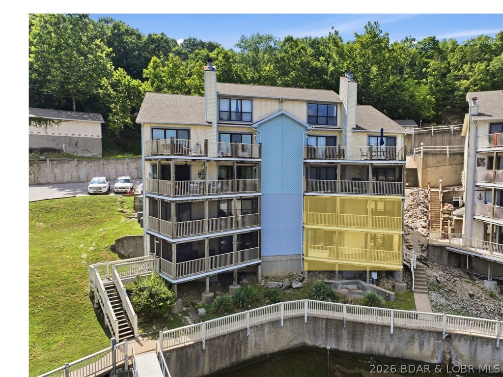 Welcome to your two-level lakefront retreat in the heart of the highly desirable Big Niangua! Whether you're searching for a full-time residence or weekend retreat, this move-in-ready condo offers everything you need to start enjoying lake life the day you close. Just steps from the water, the community dock, pool, and clubhouse are an easy walk away, making spending the day on the lake effortless. This unit includes one boat slip, two PWC slips, and a garage. The included garage offers valuable storage for vehicles, golf carts, lake toys, fishing equipment, and all the extras that come with enjoying the lake lifestyle.  Another standout feature of this home is the screened-in porch. Take in the fresh air while enjoying a cup of coffee or an evening cocktail. If you've been looking for a lakefront condo with generous living space, exceptional dock amenities, a garage, and a fantastic location, this property checks all the boxes. Opportunities like this don't come along often. Start living the lake lifestyle you've always dreamed about in this fully furnished, beautifully maintained condominium where every day feels like a vacation.