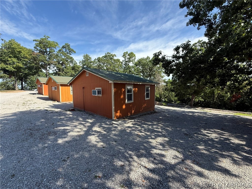 Cabin 1 & Cabin 2 are single-unit layouts, each with two full-size beds and a hide-a-bed, kitchenette with 4-burner cooktop, refrigerator, and toaster oven, plus full bath. Cabin 3 is a single-room unit with one king-size bed, kitchenette with 4-burner cooktop and refrigerator, toaster oven, and full bath. Just down the road from Truman State Park Marina giving you quick and easy access to Truman Lake, while also being close to Drake Harbor where you can access the Lake of the Ozarks. All three cabins have been successful rentals and have a long clients list. Would make for a great income producing opportunity.