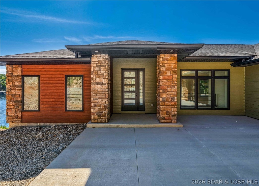 NEW CONSTRUCTION WATERFRONT HOME | HORSESHOE BEND  Exceptional new-construction lake home, main-channel views, in a large, protected cove.  Thoughtfully designed for both full-time living and weekend escapes, this impressive two-level home combines luxury, comfort, and functionality in a setting made for enjoying lake life. The home features Four Bedrooms, each with en-suite Bath, plus two half baths. Two-level design includes two beautifully appointed kitchens, featuring Hickory cabinetry and Quartz countertops, two living areas and two laundry rooms. Ideal for accommodating family, guests, or multiple generations with plenty of privacy. Large windows take full advantage of the views and waterfront setting. Step outside to enjoy the Covered Upper Deck, Covered Lower Level Patio and Pool with Electric Cover. A nice dock envelope will add easy access to the water, while the oversized two-car garage provides excellent space for vehicles, lake toys, and storage. The location offers the best of both worlds by car or boat. Shopping, dining, entertainment, and countless recreational opportunities nearby on and off the water.  Perfect spot to enjoy everything the Lake has to Offer.