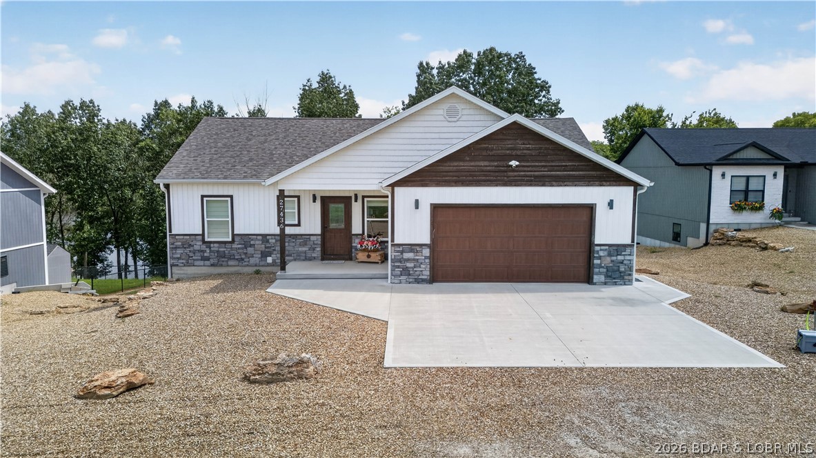 Enjoy waterfront living in this stunning 4-bedroom, 2.5-bath home built in 2023, offering just under 2,500 square feet of thoughtfully designed living space. This beautiful home features a finished walkout basement, an attached 2-car garage, upgraded laminate flooring, granite countertops, and a spacious open layout perfect for everyday living and entertaining. The primary suite includes a largewalk-in closet, while the safe room and oversized pantry provide exceptional storage and peace of mind. Step outside to enjoy the covered deck and covered patio overlooking the water, with a concrete driveway leading directly to the home. One of the standout features is the easy access to the covered boat dock—drive right to your dock with no steps required! Additional lot comes with the property perfect for your dream shop or extra parking! Located just off blacktop roads,this property also offers high-speed internet availability and is conveniently situated near several popular lakefront bars and marinas, making it easy to enjoy everything lake life has to offer. Whether you're looking for a full-time residence or the perfect waterfront getaway, this property checks all the boxes.