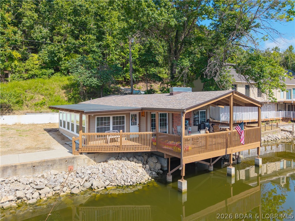 Incredible views with two beautiful homes that set the stage for this one-of-a-kind property. This property has with 140 Feet of lakefront, 68'X40' Concrete Dock, 3 slips, large swim platform and swim ladder, 2 Boatlifts, dual PWC lift, as well as 2 more separate PWC lifts,It is like having your own resort. New windows and tile floors have just been installed and the wonderful covered deck that sits out over the water is absolutely beautiful. Potentially, both houses can be used as vacation rentals providing an excellent income. The large private cove is wonderful for swimming, with all the Lake activities. All the popular places to go on the lake are close by water as well as by road. Great shopping near by and all the nightlife and wonderful events the Lake has to offer. Again this is a one-of-a-kind property that has so much to offer with so much potential, can be used for private family homes or rental income. This is a must see!!!
