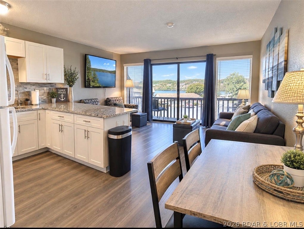 Jump straight into Lake-life fun with this beautifully updated 1-bedroom, 1-bathroom condo at popular Weston Point! Modern updates shine throughout, featuring stylish kitchen cabinetry, sleek granite countertops, an eye-catching backsplash, and durable, easy-care flooring. Tastefully decorated and sold furnished—just bring your toothbrush and swimsuit! Boaters dream, includes a 10' x 24' boat slip with lift PLUS a dedicated PWC slip with lift. Prime Location at the 24MM in Osage Beach (off Route KK)—minutes by land or water to Margaritaville, top waterfront dining, and local hotspots. Enjoy Weston Point's lush, park-like setting, sparkling lakeside pool, tennis court, on-site laundry, and convenient boat trailer parking. Experience the quiet enjoyment of second-tier living without sacrificing main-channel views. Whether you're looking for a budget-friendly personal lake retreat or a proven income producer with established rental history to grow your investment portfolio, this turn-key condo delivers it all.
